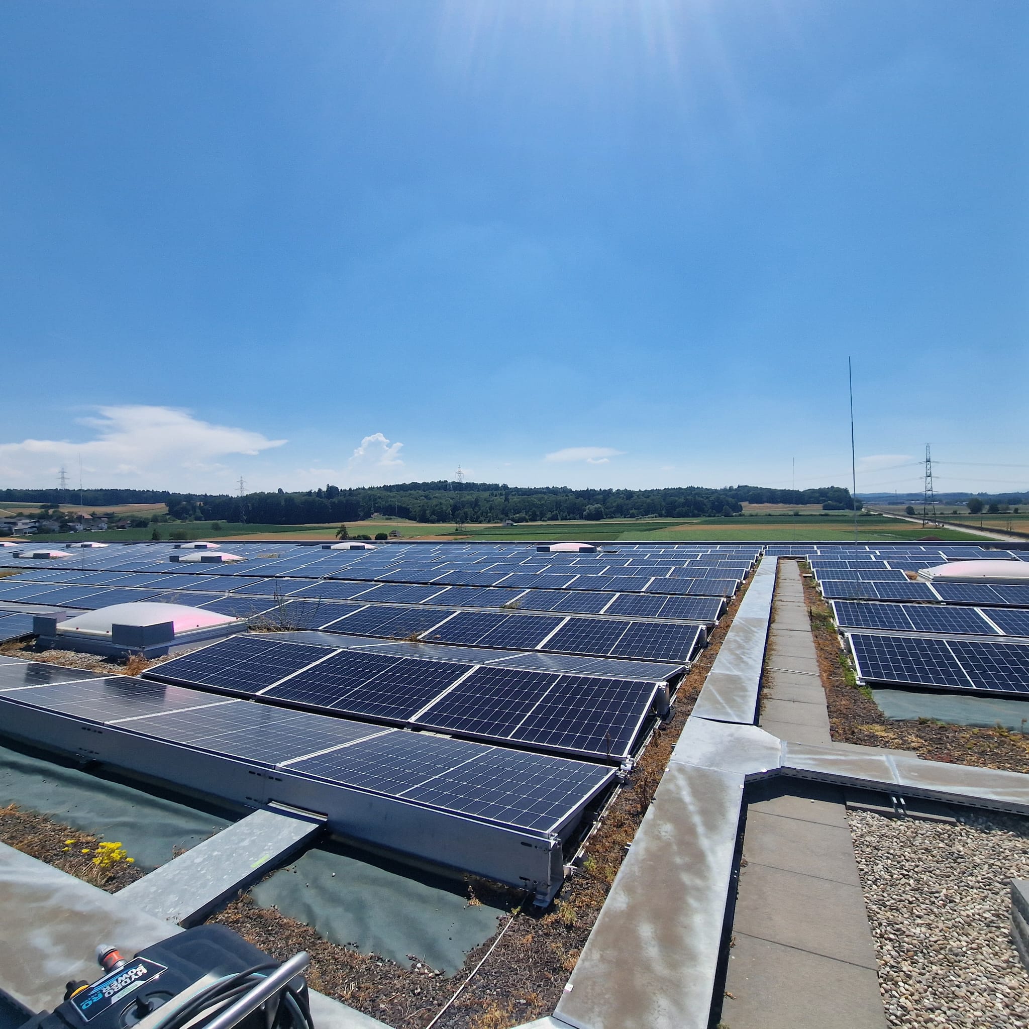 Grossflächige Photovoltaikanlage auf dem Flachdach eines Industriegebäudes